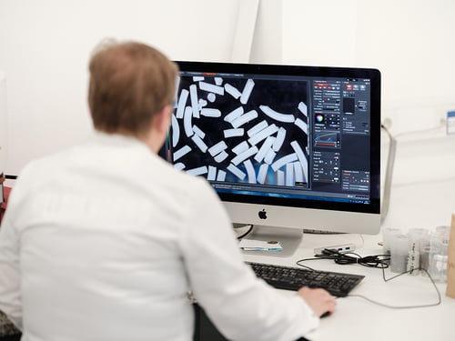 Weiler co-worker analyzing abrasive grains for a new product improvement project 