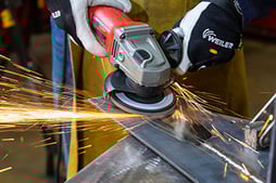 An operator uses a flap disc to blend a weld into the base material. Many options for grit size and type are available to adjust the flap disc’s performance and life.