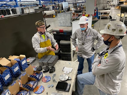 David Jescovitch, abrasives specialist manager with Weiler Abrasives, visits with workers in a shipbuilding facility as part of the product testing process.