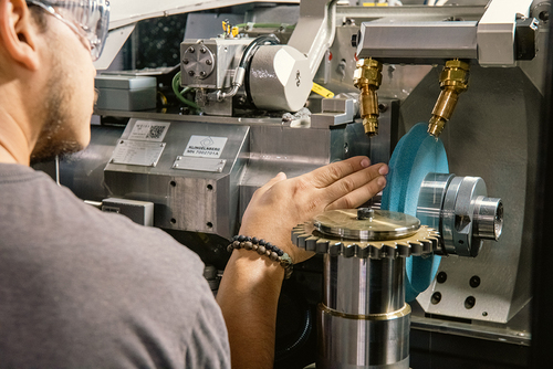 Operator inspecting a profile grinding wheel for wear