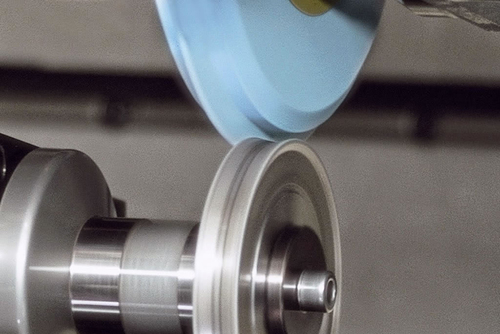 Profile grinding wheel being dressed to achieve the required tooth profile